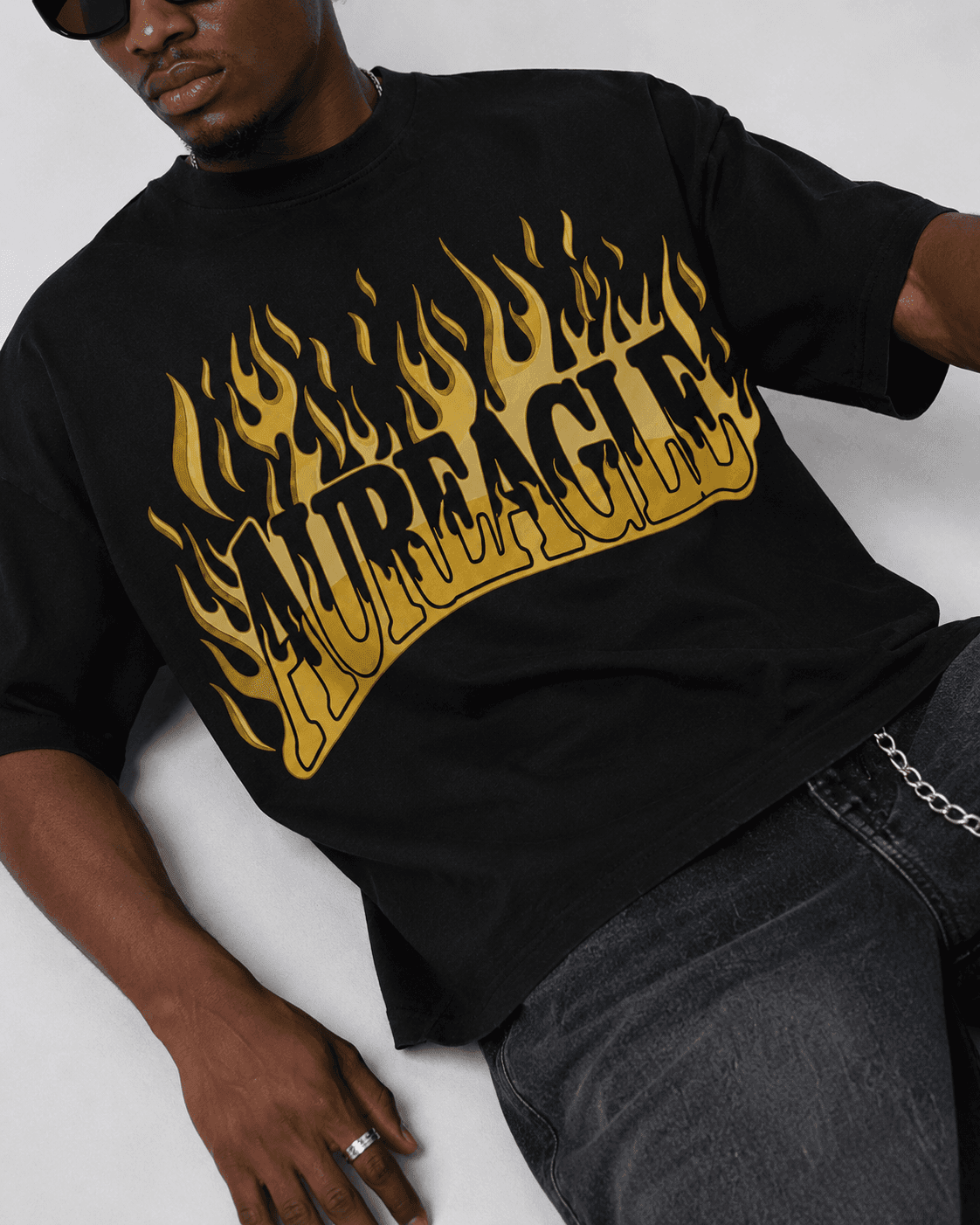 Close view of the gold flame print on the Ignite Oversized Tee